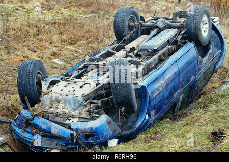 upside down car, car accident, road accident, car in a ditch Stock Photo