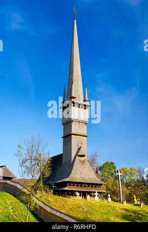 Wooden 18th c. Catholic Church, village of Surdesti, Maramures,  Romania, UNESCO Stock Photo