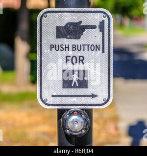 Push button for pedestrian crossing sign on a road Stock Photo