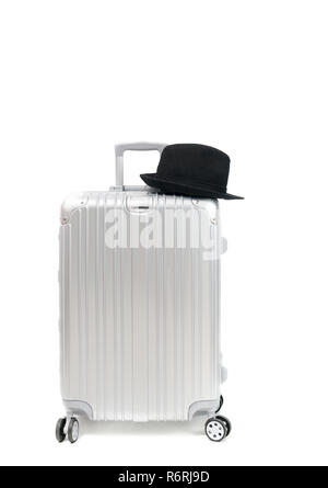 Aluminum Travel Suitcase and black hat isolated on white background, travel concept Stock Photo