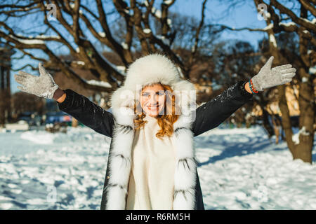 Winter girl in fur hat and coat outdoors Stock Photo