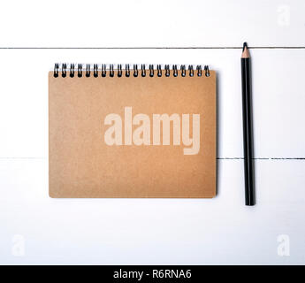 notebook on a black iron spring with brown empty sheets Stock Photo