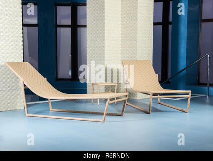 Chaise longue by pool Stock Photo