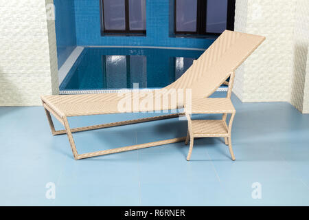 Chaise longue by pool Stock Photo