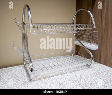 Dish dryer stands on the kitchen table Stock Photo
