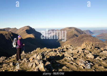 Walker on the Summit of Green Gable with the View West over Ennerdale and Buttermere, Lake District, Cumbria, UK Stock Photo