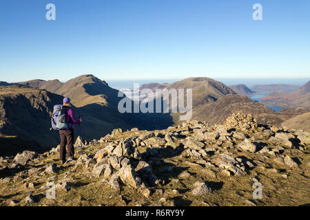 Walker on the Summit of Green Gable with the View West over Ennerdale and Buttermere, Lake District, Cumbria, UK Stock Photo