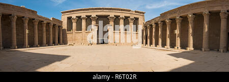 Hieroglypic carvings on wall and columns at the entrance to ancient egyptian temple of Horus in Edfu Stock Photo