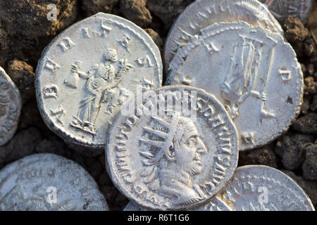 Roman silver coins covered in dirt Stock Photo