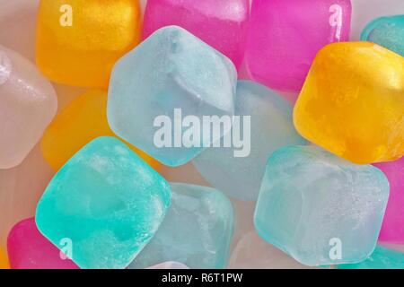 A colorful assortment of plastic ice cubes with a light coating of frost on them. Stock Photo