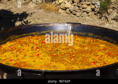 Paella being cooked on an Open Fire at a Village Fiesta in the  Almanzora Valley, Almeria province, Andalucía, Spain Stock Photo