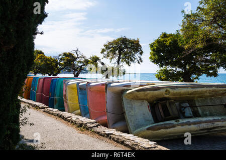 The end of summer season; colorful pedal boats / pedalos getting stored on the beach in Macedonia. Stock Photo