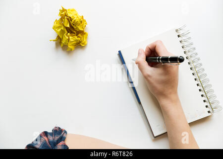Creative writing concept with notebook and crumpled paper balls. Editing and copywriting workplace. Stock Photo