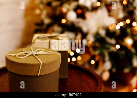 Festive Gifts with Boxes, Coniferous, Basket on blurred christmas tree Background. Christmas Presents Toned in Vintage Style.Christmas and New Year Decoration isolated on white background. Border art design with holiday baubles. Stock Photo