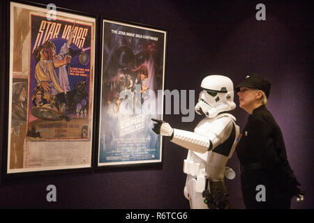 London UK. 6th December 2018. A Stormtrooper and Imperial Officer view  the original Star Wars posters  at the Bonhams photocall Credit: amer ghazzal/Alamy Live News Stock Photo