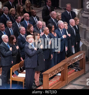 Dignitaries pay their respects as the casket containing the remains of the late former United States President George H.W. Bush at the National funeral service in his honor at the Washington National Cathedral in Washington, DC on Wednesday, December 5, 2018. Front row: United States President Donald J. Trump, first lady Melania Trump, former US President Barack Obama, former US President Bill Clinton, former US Secretary of State Hillary Rodham Clinton, former US President Jimmy Carter, former first lady Rosalynn Carter. Second row: US Vice President Mike Pence, Karen Pence, former US Vice Stock Photo