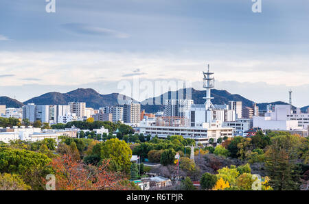 Himeji, Hyogo, Japan - November 23, 2018: Aerial view on city of Himeji covered by colorful tree in autumn season taken from Himeji castle. Stock Photo