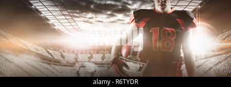 Young volleyball player holding rugby helmet Stock Photo