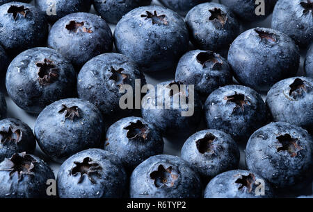 A macro shot of blueberries covered in water drops. Stock Photo