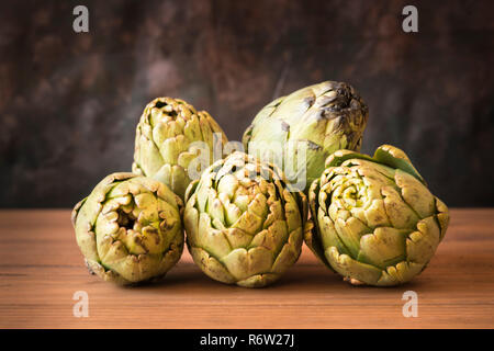 Healthy and vegetarian food concept. Still life with artichokes on wooden table. Stock Photo