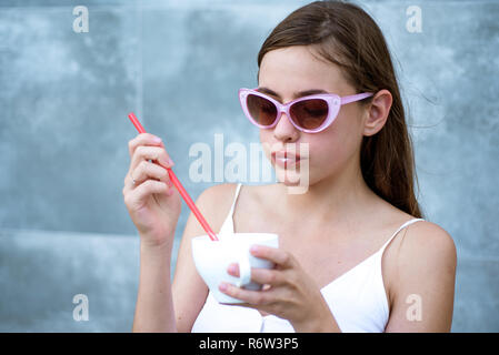 Start the day with great taste. Pretty woman sip beverage with drinking straw. Cute woman drink through straw in cafe. Fashionable woman enjoy sipping drink through straw. Savor the flavor Stock Photo