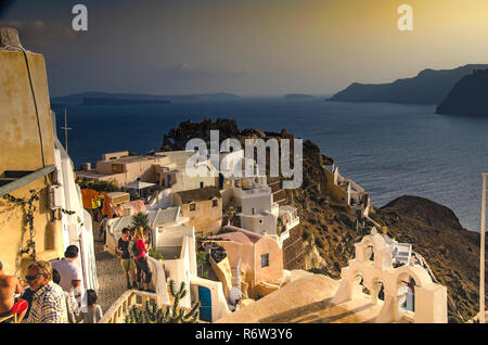 Sundown over the villa of Oia built on the mountain top with its slopes modeled by volcanic eruptions. Stock Photo