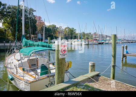 Sailboats tied up and lined up in boat slips at Fly Creek Marina on Mobile Bay, in Fairhope Alabama, USA. Stock Photo