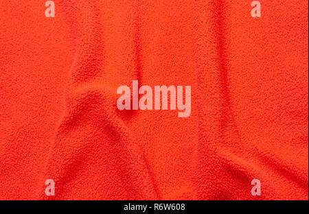 Red soft fleece texture. The surface of a teddy crumpled microfiber rug Stock Photo