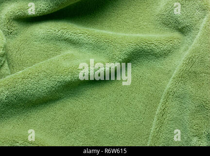 Green soft  fleece texture. The surface of a teddy crumpled microfiber rug Stock Photo