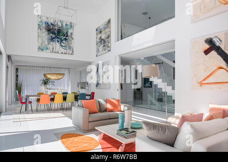 Double height living and dining room with large artworks in in new build villa, Quinta do Lago Stock Photo