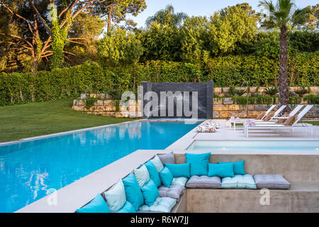Sunken seating area among pools of water and shaded structures of new build villa, Quinta do Lago Stock Photo