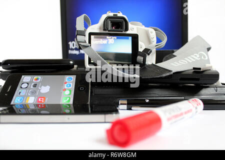 Technology set, Camera Canon 100d, laptop lenovo thinkpad, apple iphone 4s, presenter, microsoft windows, external hard drive Stock Photo