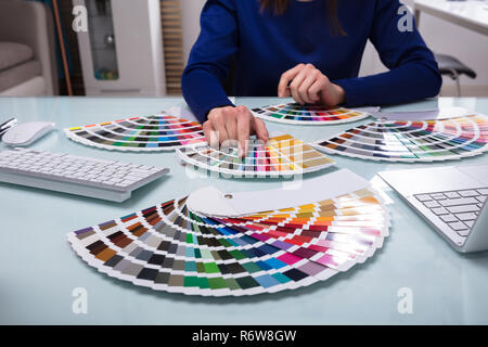 Designer Choosing Color From Color Swatches Stock Photo