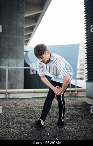Freerunner Stretching on a Rooftop Stock Photo