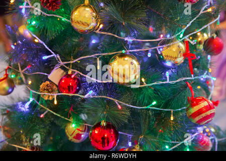 A Christmas ball hangs on the background of a clock. It's time for a new year. Multicolored glare and brilliance. Gold box Stock Photo