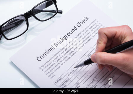 Person Filling Criminal Background Check Form Stock Photo