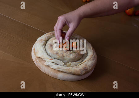 spiral filo pie burek with cherry tomatoes Stock Photo