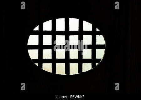 phot from the dark interior of an oval metal grid with the illuminated exterior Stock Photo