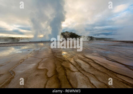 Steam rises from the Grand Prismatic Spring area of Yellowstone National Park in Wyoming at sunrise. USA Stock Photo