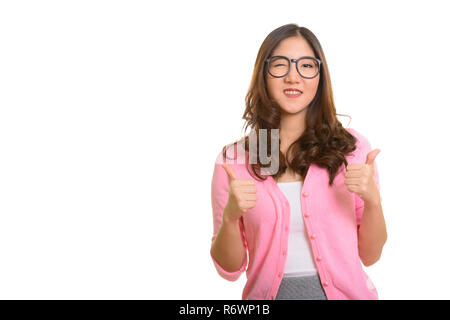 Young happy Asian woman giving thumbs up and winking Stock Photo