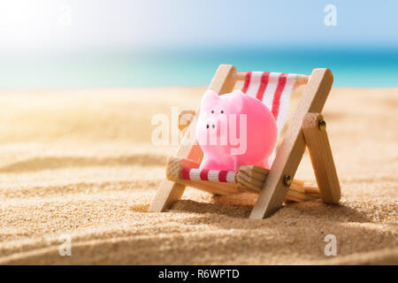 Pink Piggy Bank On Deck Chair Stock Photo
