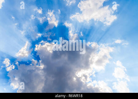 White clouds and sunrays on blue sky Stock Photo