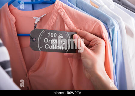 One hundred percent cotton label tag on clothing Stock Photo - Alamy