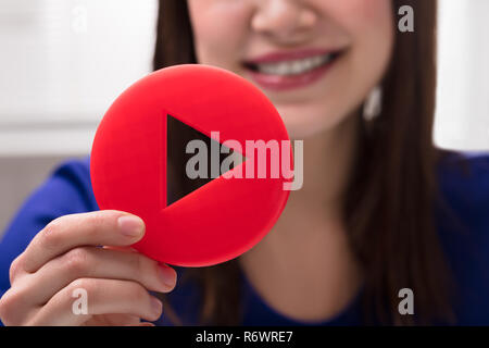 Woman's Hand Holding Play Icon Stock Photo