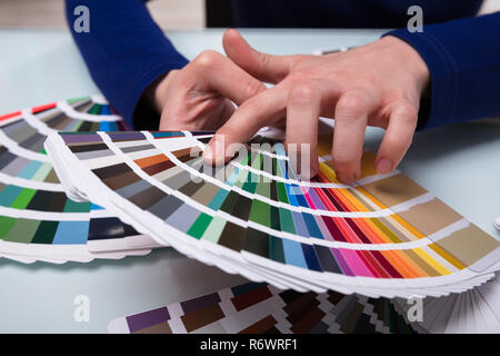 Designer Choosing Color From Color Swatches Stock Photo