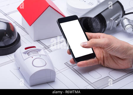 Architect's Hand Using Mobile Phone Stock Photo