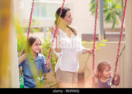 Mother with two daughters on playground Stock Photo