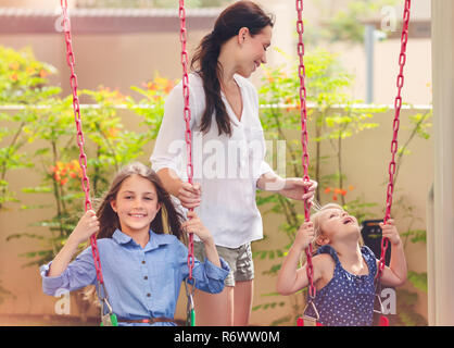 Mother with two daughters on playground Stock Photo