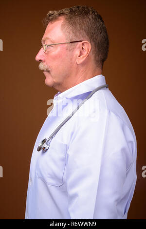 Profile view portrait of senior man doctor with mustache Stock Photo
