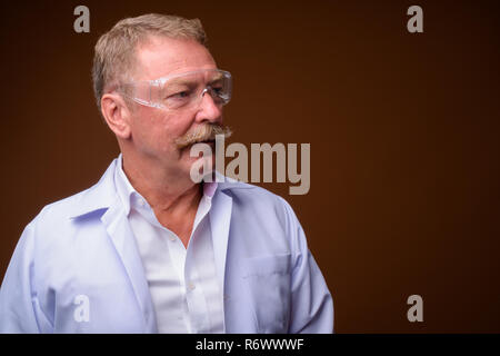 Senior man doctor or scientist wearing protective glasses Stock Photo